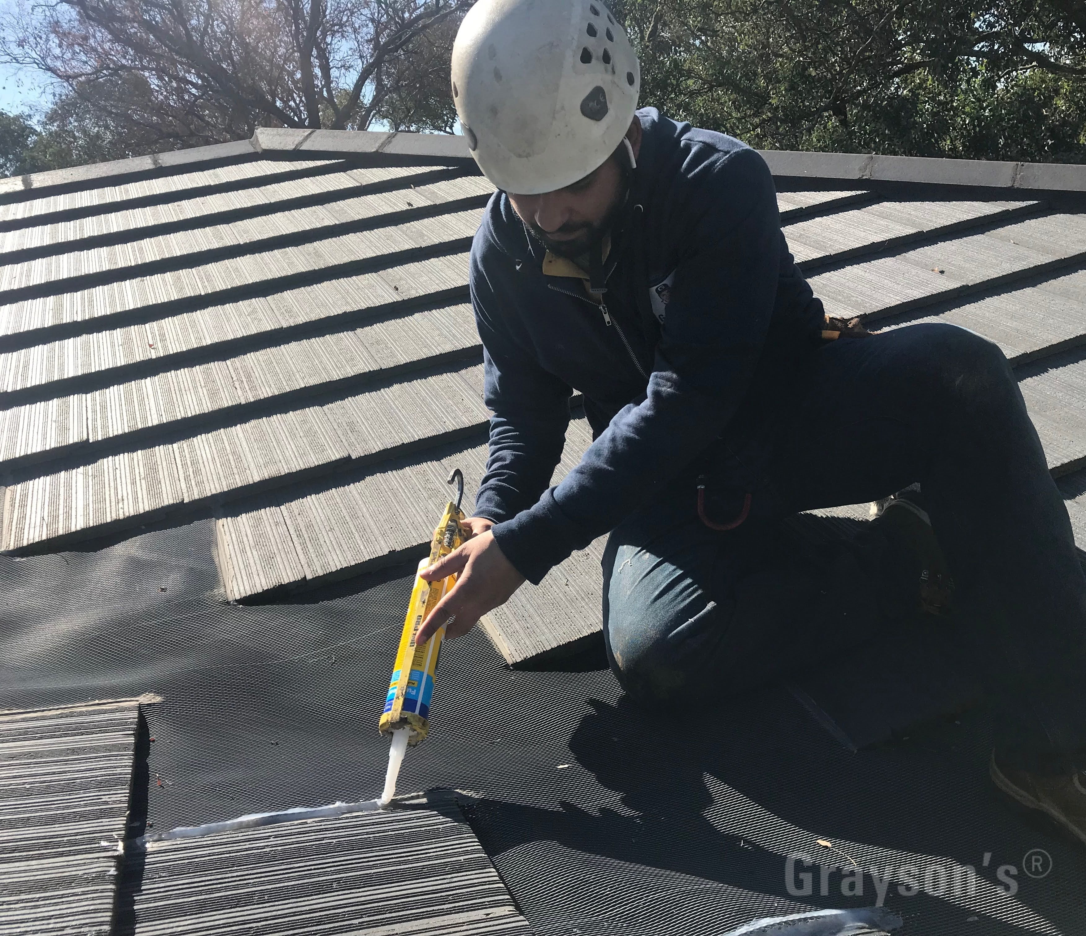 Repairing a gutter guard system that's fitted to completely cover a valley. We recommend against this type of install, but we are happy to service existing valley gutter mesh.