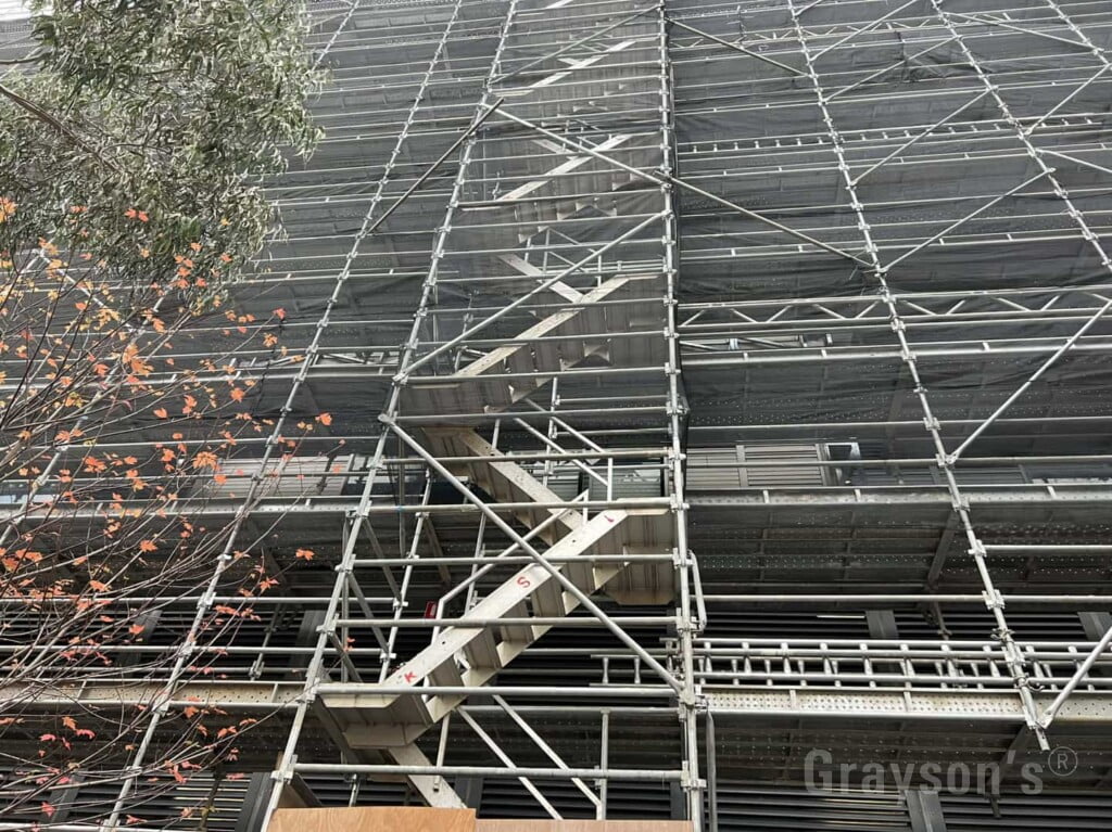 Scaffolding on a multi-storey building with an access staircase.