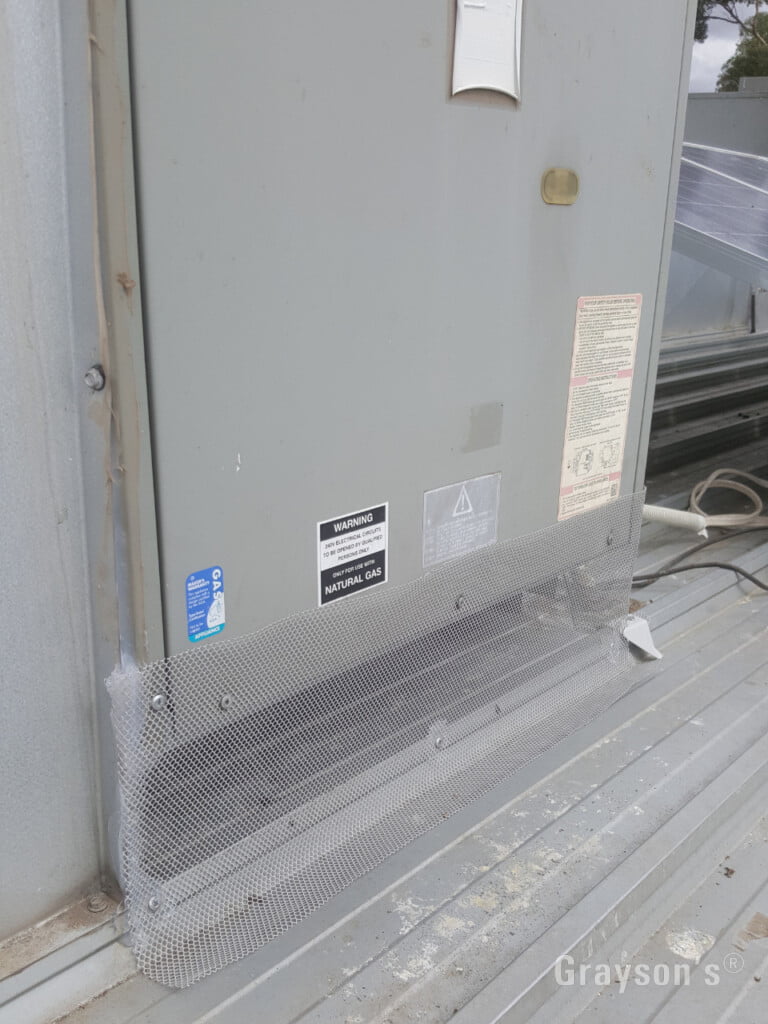 Bird proofing mesh under an airconditioning unit