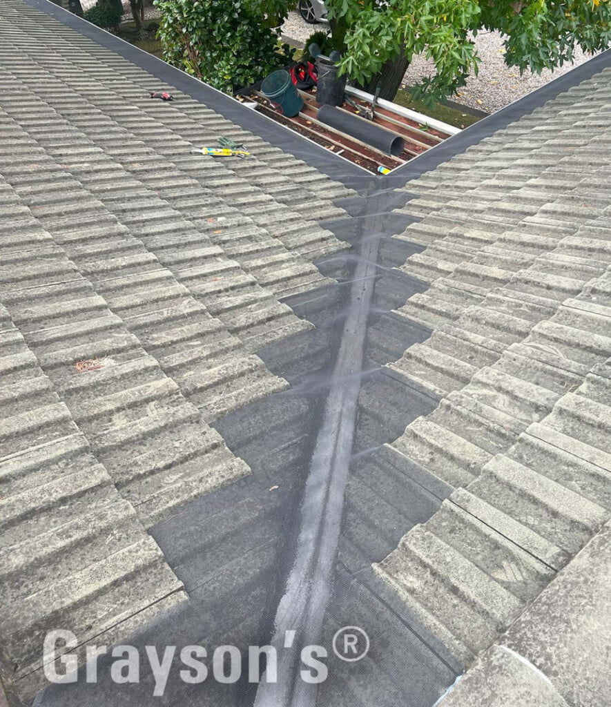 Gutter guard installed by Grayson's in the valley of a tiled roof